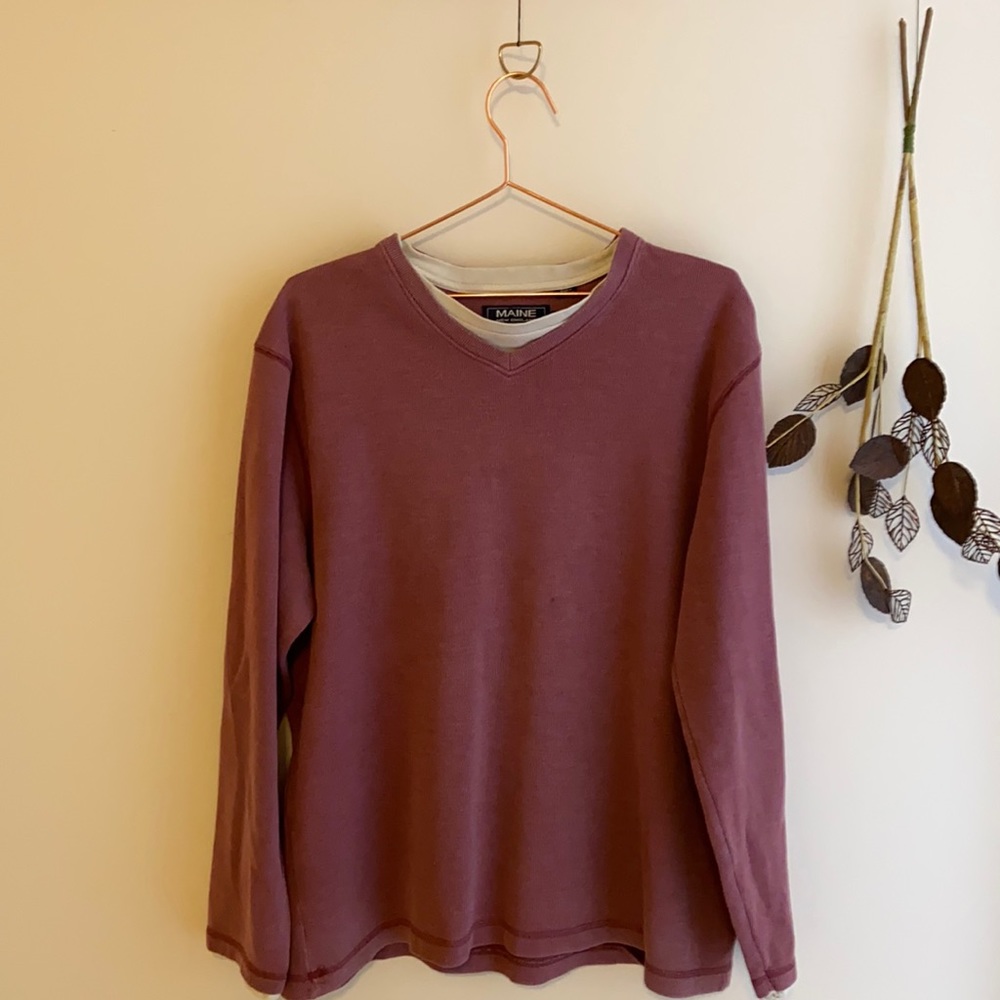 Men’s red jumper with white collar detail.